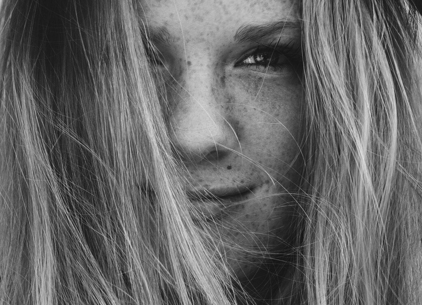 Image of woman's face with freckles for busy woman's guide to skincare routine blog post